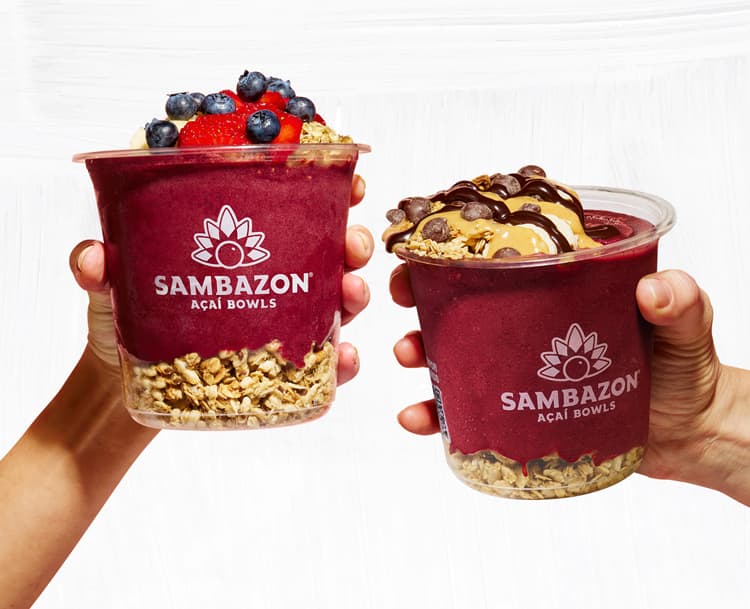 Two SAMBAZON Acai bowls saying a cheers zoomed in.