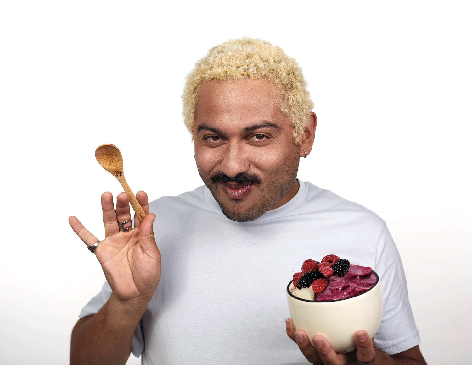 person enjoying the taste of a bowl made with acai packs